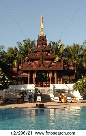 Stock Image - Temples around a pool area in Mandalay. Fotosearch