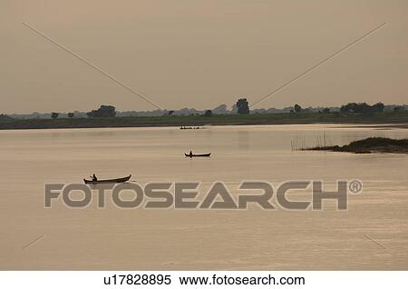 Stock Photography - Boats on the Irrawaddy River. Fotosearch