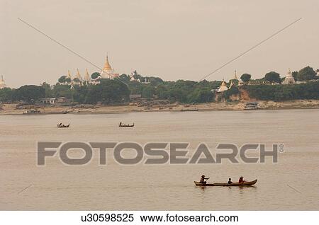 Stock Photography - Boats on the Irrawaddy River. Fotosearch