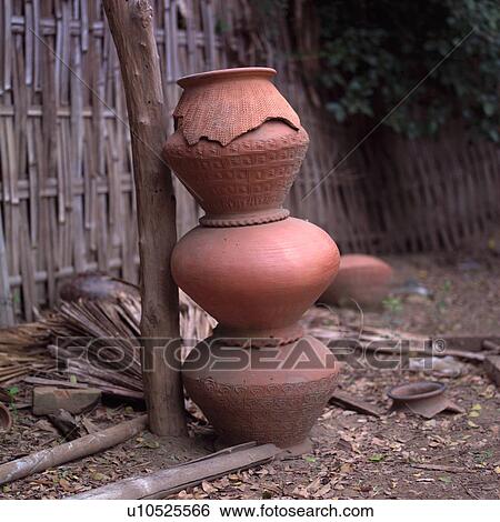 Stack of Pottery leaning against a tree View Large Photo Image Stock Photograph - Stack of Pottery leaning against a tree. Fotosearch