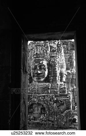 Stone carving of a face on wall at Khmer Kingdom palace ruins View Large Photo Image Stock Image - Stone carving of a face on wall at Khmer Kingdom palace ruins. Fotosearch