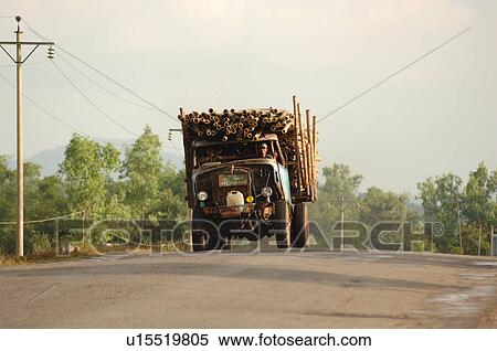 Stock Photography - Truck carrying logs driving towards camera. Fotosearch