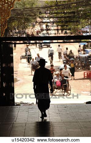 Stock Image - Back view of Burmese man walking away. Fotosearch