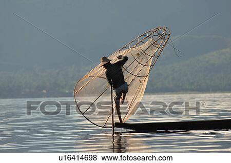 Stock Photo - Fisherman in row boat. Fotosearch