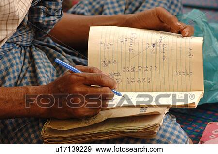 Stock Photo - Person writing in book. Fotosearch