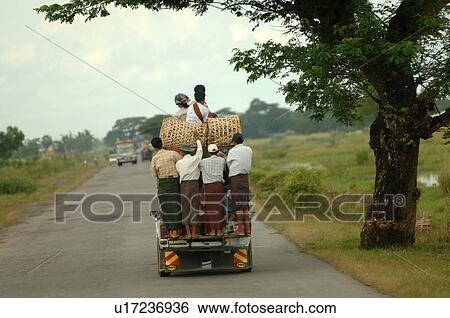 Truck driving away full of people View Large Photo Image Stock Photograph - Truck driving away full of people. Fotosearch