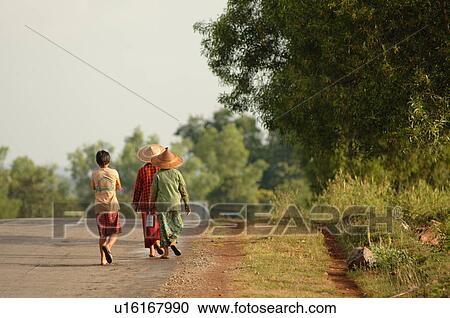 Two Burmese ladies and boy walking away View Large Photo Image Stock Image - Two Burmese ladies and boy walking away. Fotosearch