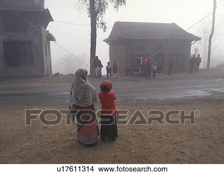 Picture - Woman and Child in Fog by Road - Nepal. Fotosearch