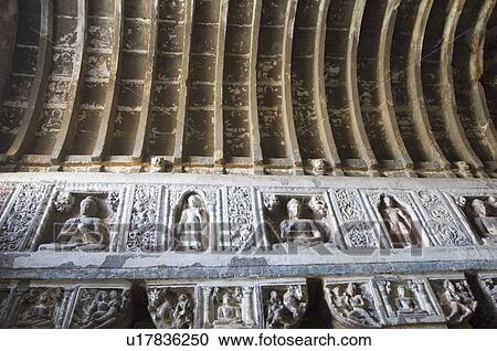 Stock Image - Carvings in a cave, Ajanta, Maharashtra, India. Fotosearch