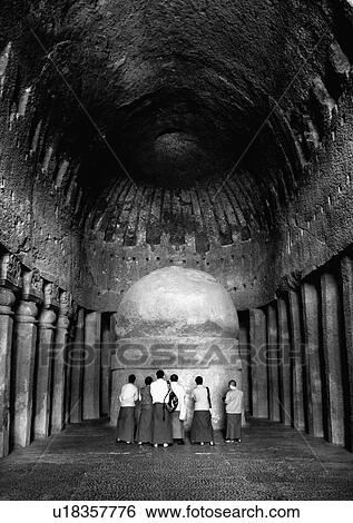 Rear view of Monks praying in front of a sculpture, Kanari Cave, Mumbai, Maharashtra, India View Large Photo Image Stock Photograph - Rear view of Monks praying in front of a sculpture, Kanari Cave, Mumbai, Maharashtra, India. Fotosearch