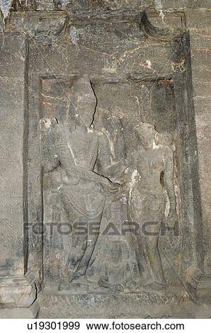 Stock Photo - Statues of Hindu god and goddess carved in a cave, Ellora, Aurangabad, Maharashtra, India. Fotosearch