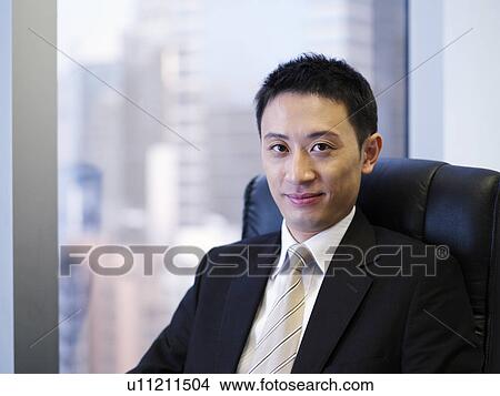 Businessman sitting in office chair, portrait View Large Photo Image Picture - Businessman sitting in office chair, portrait. Fotosearch