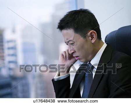 Stock Photo - Businessman using mobile phone. Fotosearch