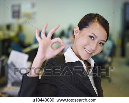 Businesswoman Communicating With OK Hand Gesture View Large Photo Image Stock Image - Businesswoman Communicating With OK Hand Gesture. Fotosearch