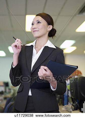 Stock Photo - Businesswoman Holding a Pen. Fotosearch