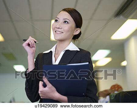 Stock Photo - Businesswoman Holding a Pen. Fotosearch