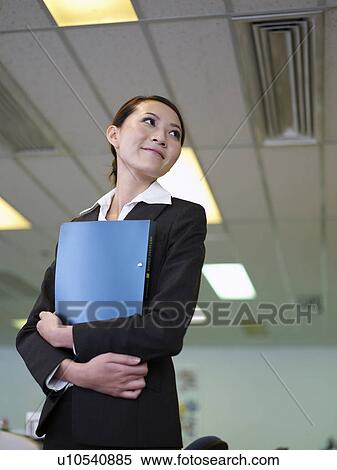 Stock Photography - Businesswoman holding files. Fotosearch