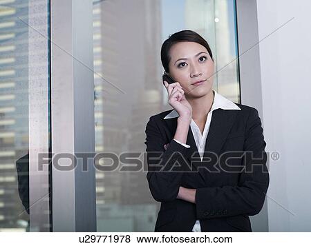 Businesswoman holding mobile phone View Large Photo Image Stock Photo - Businesswoman holding mobile phone. Fotosearch