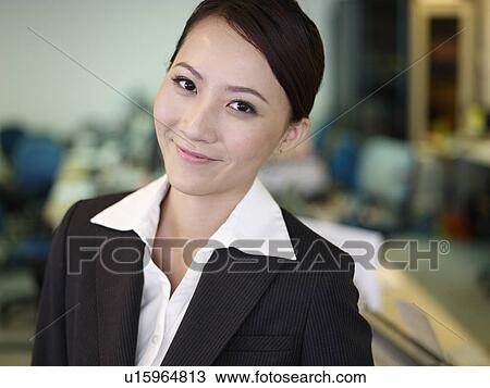 Stock Image - Businesswoman in office, close-up, portrait. Fotosearch
