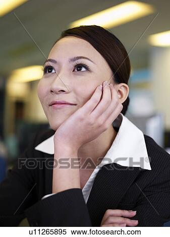 Stock Photography - Businesswoman looking away, smiling. Fotosearch