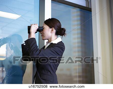 Businesswoman looking through binoculars View Large Photo Image Stock Photo - Businesswoman looking through binoculars. Fotosearch