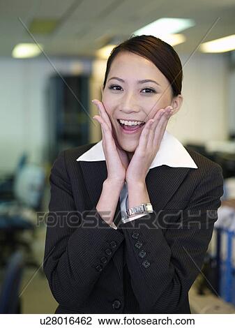Businesswoman placing hand aside cheek, portrait View Large Photo Image Stock Image - Businesswoman placing hand aside cheek, portrait. Fotosearch