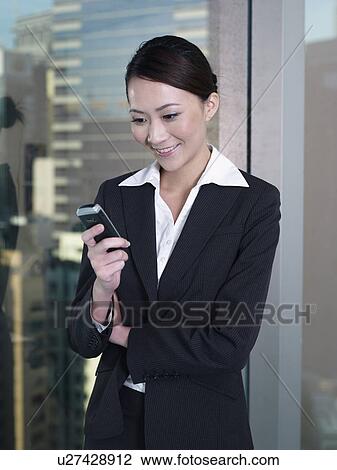 Businesswoman receiving text message View Large Photo Image Stock Image - Businesswoman receiving text message. Fotosearch