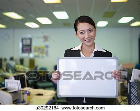 Businesswoman woman holding blank white board View Large Photo Image Picture - Businesswoman woman holding blank white board. Fotosearch