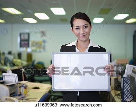 Businesswoman woman holding blank white board View Large Photo Image Stock Image - Businesswoman woman holding blank white board. Fotosearch