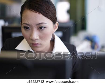 Stock Image - Businesswoman working on a computer. Fotosearch