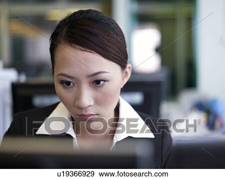 Stock Photo - Businesswoman working on a computer. Fotosearch