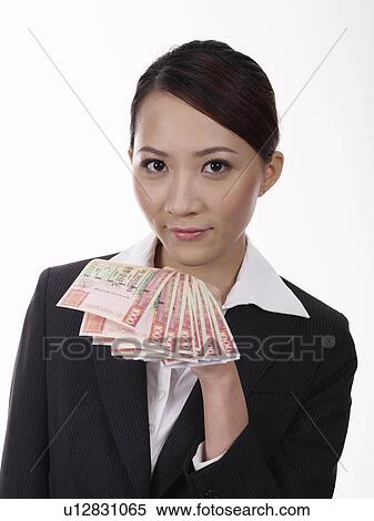 Stock Photography - Businesswoman holding banknotes. Fotosearch