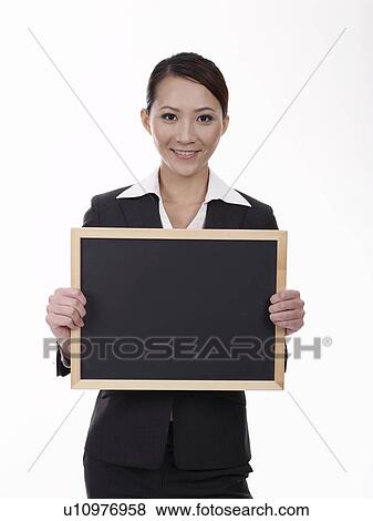 Stock Photo - Businesswoman holding blackboard. Fotosearch