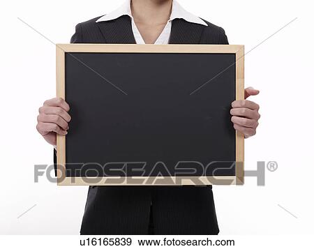 Businesswoman holding blackboard View Large Photo Image Stock Photo - Businesswoman holding blackboard. Fotosearch