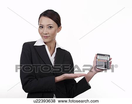 Stock Photo - Businesswoman holding calculator. Fotosearch