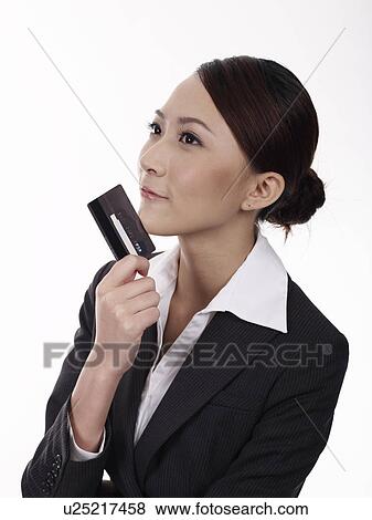 Businesswoman holding credit card, studio shot View Large Photo Image Stock Photo - Businesswoman holding credit card, studio shot. Fotosearch