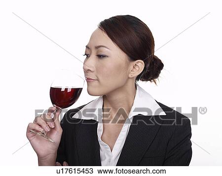 Businesswoman holding glass of wine View Large Photo Image Stock Image - Businesswoman holding glass of wine. Fotosearch