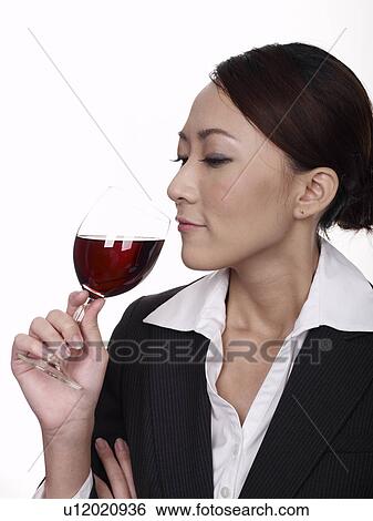 Stock Photograph - Businesswoman holding glass of wine. Fotosearch