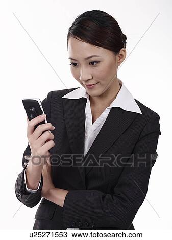 Businesswoman holding mobile phone, close-up View Large Photo Image Stock Image - Businesswoman holding mobile phone, close-up. Fotosearch