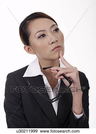 Businesswoman holding spectacles, looking away, close-up View Large Photo Image Stock Photo - Businesswoman holding spectacles, looking away, close-up. Fotosearch