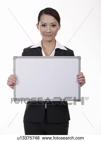 Businesswoman holding whiteboard View Large Photo Image Stock Photo - Businesswoman holding whiteboard. Fotosearch