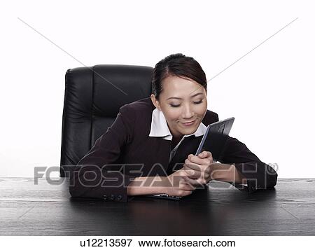 Stock Photo - Businesswoman hugging laptop, close-up. Fotosearch