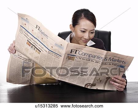 Businesswoman reading newspaper View Large Photo Image Stock Photography - Businesswoman reading newspaper. Fotosearch
