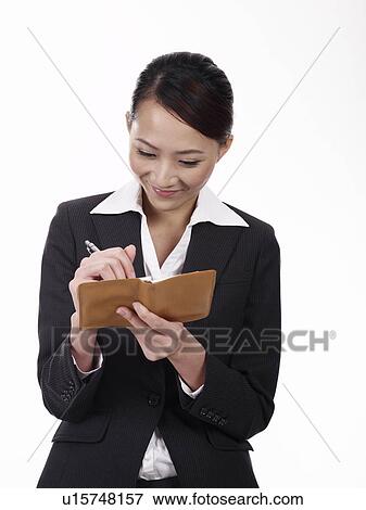 Stock Photo - Businesswoman taking notes. Fotosearch