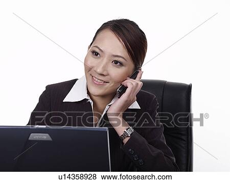 Stock Photo - Businesswoman talking on mobile phone. Fotosearch