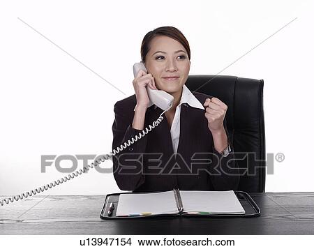 Picture - Businesswoman talking on phone and smiling. Fotosearch