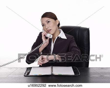 Stock Image - Businesswoman talking on phone. Fotosearch