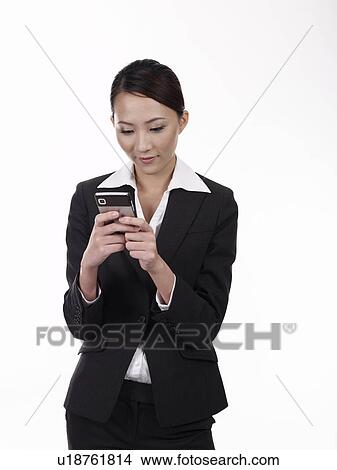 Businesswoman text messaging View Large Photo Image Picture - Businesswoman text messaging. Fotosearch