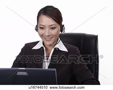 Businesswoman using laptop, video conference at desk View Large Photo Image Stock Image - Businesswoman using laptop, video conference at desk. Fotosearch
