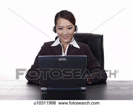 Businesswoman using laptop, video conference at desk View Large Photo Image Stock Photo - Businesswoman using laptop, video conference at desk. Fotosearch